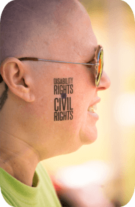 Close-up of a woman's cheek with a tattoo that readers: Disability Rights are Civil Rights