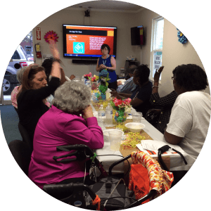A group class at the North Augusta Office with consumers looking at the screen at the end of the their table