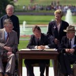 President Bush signs the Americans with Disabilities Act on the South Lawn of the White House. Sharing the dais with the President and he signs the Act are (standing left to right): Rev. Harold Wilkie of Clairmont, California; Sandra Parrino, National Council on Disability; (seated left to right): Evan Kemp, Chairman, Equal Opportunity Commission; and Justin Dart, Presidential Commission on Employment of People with Disabilities