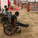 Campers tried a variety of assistive technology during camp, including wheelchairs. This group is mid-race for their wheelchair race.
