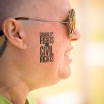 Close-up of a woman's cheek with a tattoo that readers: Disability Rights are Civil Rights
